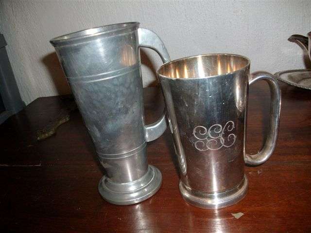 two beer mugs one sliver plate one pewter